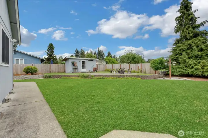 Outbuilding for garden tools and extra storage.