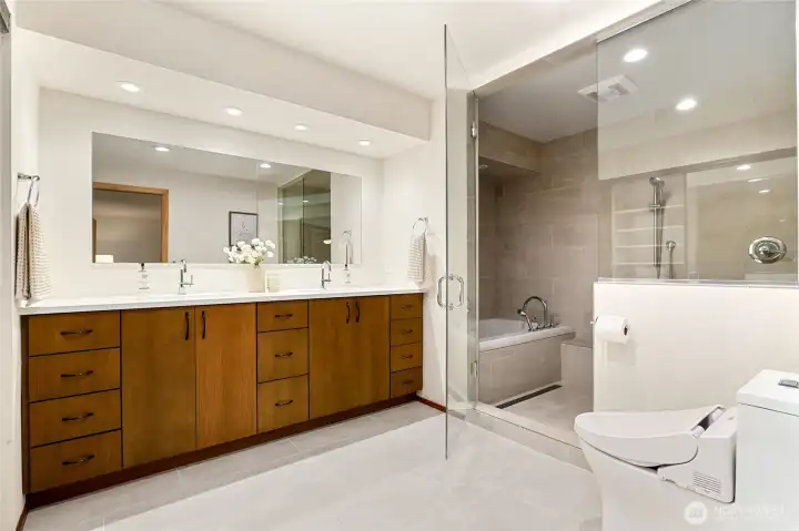 Newly updated primary bath with clean lines and modern finishes that complement the home’s mid-century style. Newly updated primary bath with clean lines and modern finishes that complement the home’s mid-century style.