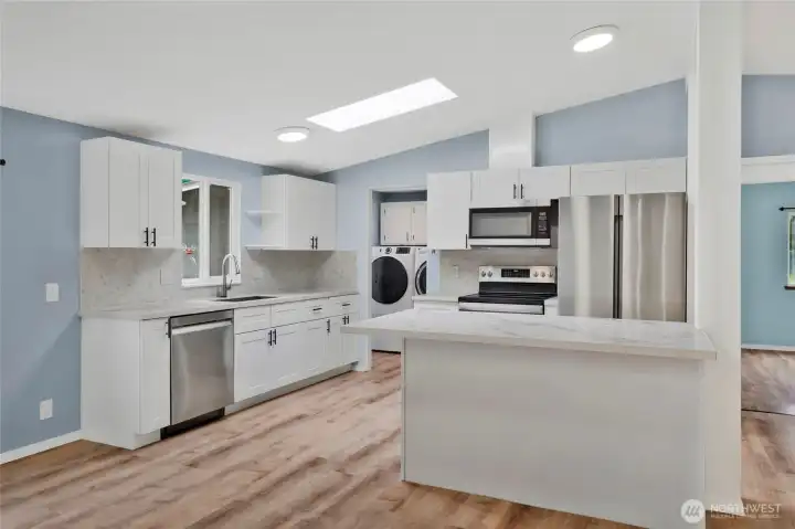 Another view of kitchen with all new stainless appliances that stay with the home