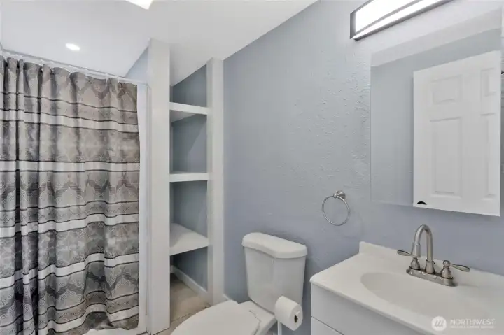 Second full bathroom with built in shelving