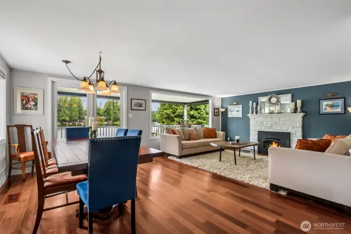 The open-concept living and dining rooms flow naturally toward the lake, creating a bright, connected space designed for everyday comfort and entertaining. French doors open wide to the large, covered deck, extending the living area outdoors in every season. With year-round usability and seamless indoor-outdoor movement, this space captures the essence of relaxed waterfront living.