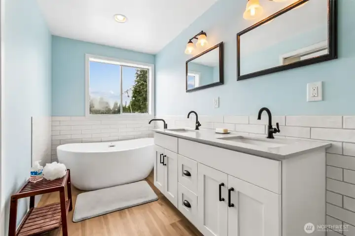 The newly renovated en suite feels fresh and serene, with crisp white finishes, and LVP flooring that brighten the entire space. A deep soaking tub invites relaxation, while the tiled shower adds both style and practicality. Enjoy views of the lake, creating a spa-like retreat right inside the owner’s suite.