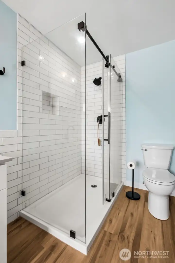 The newly renovated En Suite enjoys this beautifully tiled shower and new LVP flooring.