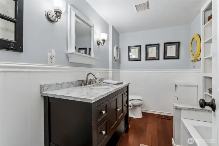 The renovated main-floor full bath features updated finishes and a clean, modern look. Its central location makes it easily accessible from all bedrooms. It’s both practical and attractive.