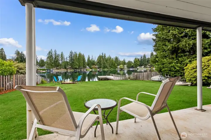 The lower patio just off of the daylight basement also offers a spacious covered area for waterfront bar-b-ques, relaxing or dining. To the right of the photo is a dedicated storage room to hold all your waterfront toys or cushions.