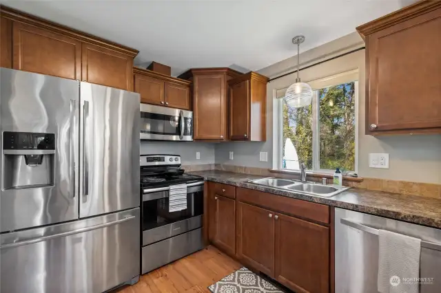 Stainless steel appliances, modern layout and sunny window