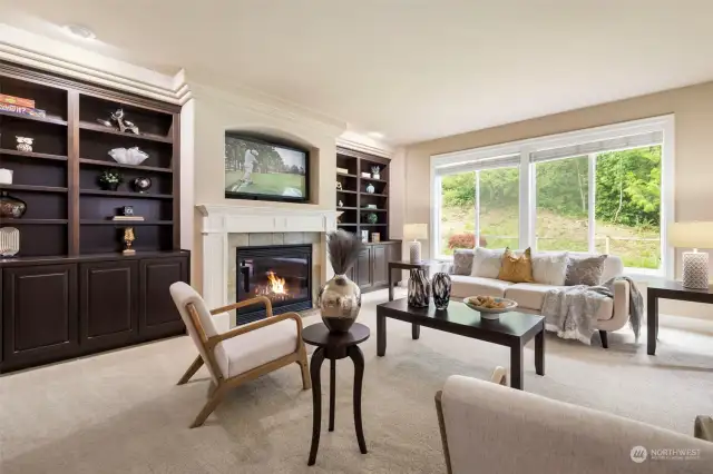 Fireplace is flanked by these beautiful built-ins. Large windows bring in the light.