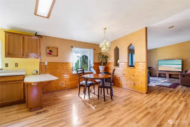 The dining room area and kitchen are just on the other side of the living room wall, and here you see the family room beyond the windowed wall. Having two living spaces is so nice!