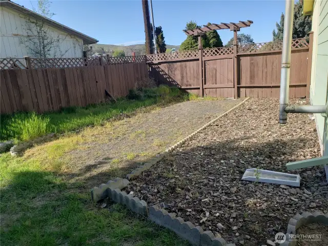 The right side of the house has a drive-through gate, with RV parking in the back yard.
