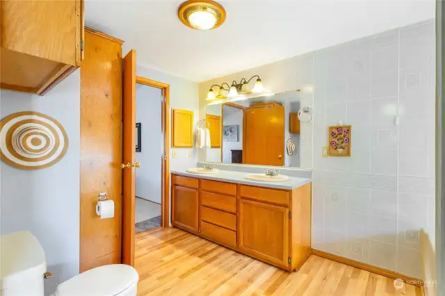 The primary bathroom has a tub, shower, and double sinks with extra storage.