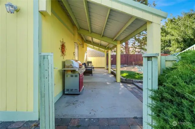 You'll just love this outdoor covered patio with a metal roof that'll last forever. Nicely shaded, just inside the thick double gates seen here (looks like posts, but it's two gates).