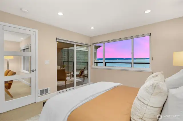 Primary with water views, skyline view, and private access to the outdoor living space.
