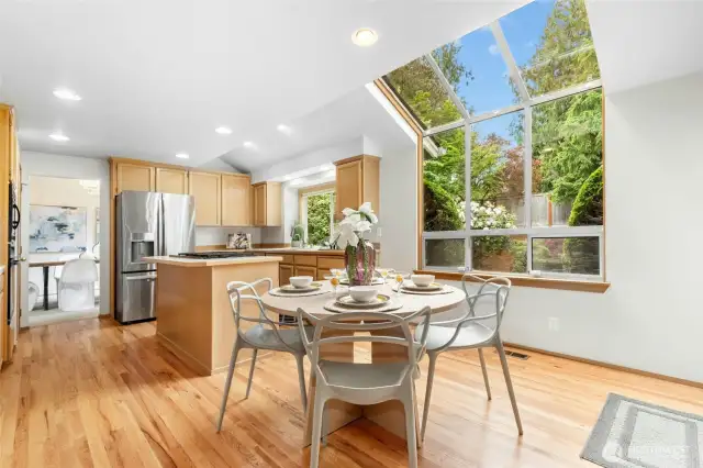 Angle including the informal breakfast nook area. Note the newly refinished hardwood flooring.