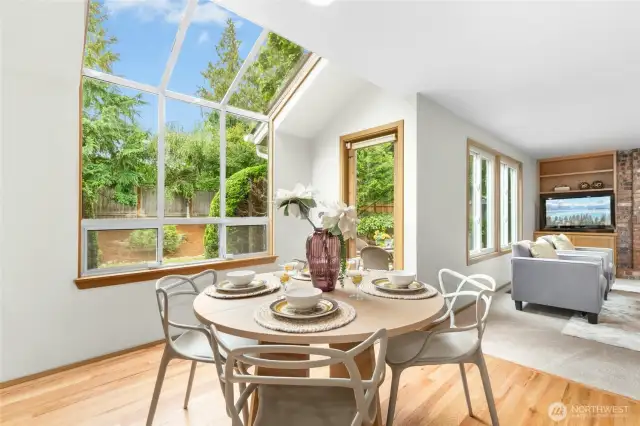Informal eating area with a light flooding garden window and a French door leading out to the backyard area.