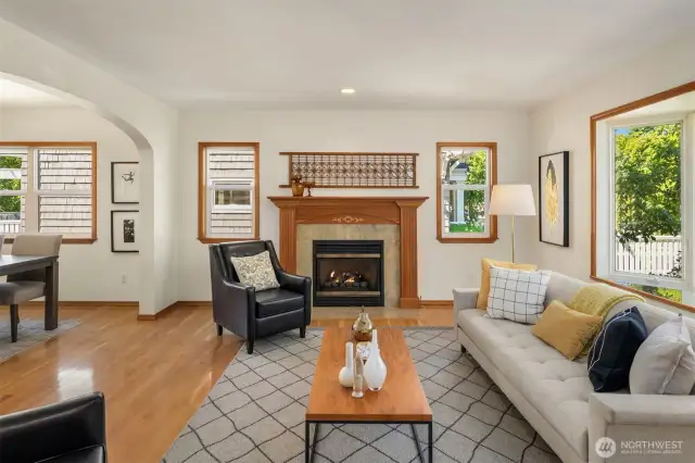 Anchored by a gas fireplace embraced in wood trim, the formal living room unfolds into the dining area.