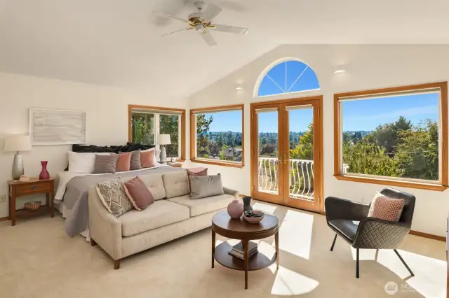 Primary bedroom located on second floor. Large windows spill light throughout the room.
