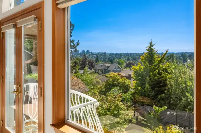 The primary bedroom features a Juliet balcony with sweeping views.