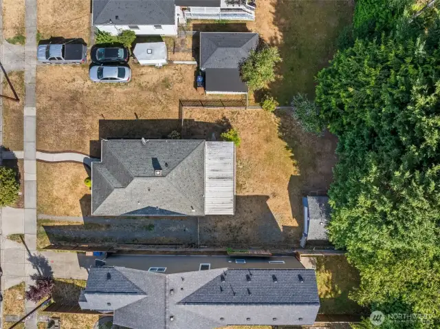 Overhead view highlights the spacious fenced yard, detached garage, and overall layout of the property
