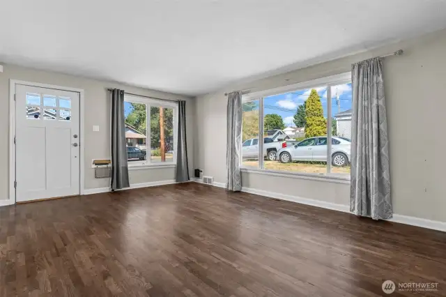Expansive window fills the space with natural light and frames the view beautifully.