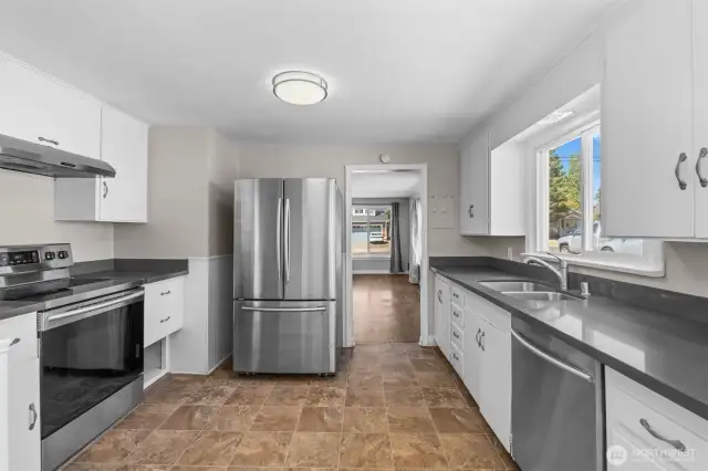 Stainless steel appliances and modern fixtures elevate the functionality of this stylish cooking space.