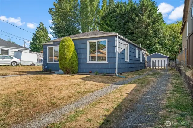 A long driveway leads to a detached garage, offering ample off-street parking and a taste of the home's generous outdoor space.