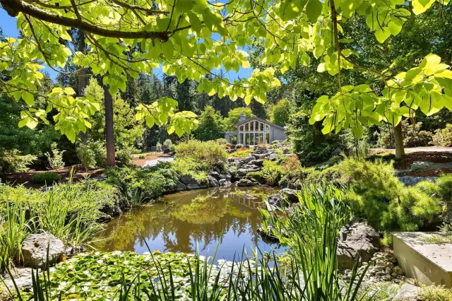 This is a view of the studio across the beautifully landscaped property with ponds and a water feature