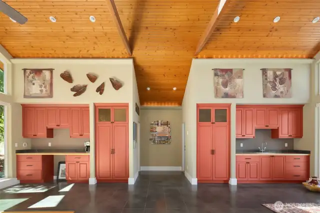 Another view of the studio showing built-in cabinetry, sink and room for a kitchenette