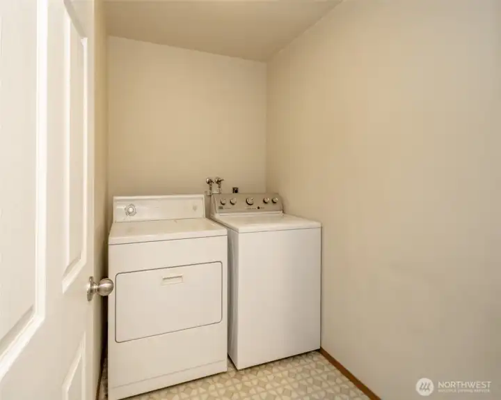 Independent laundry room with storage behind door