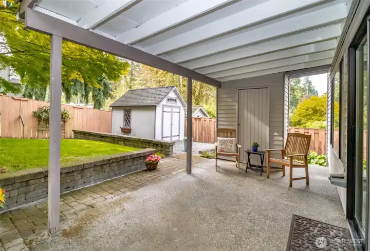 Covered patio off family room with small shed