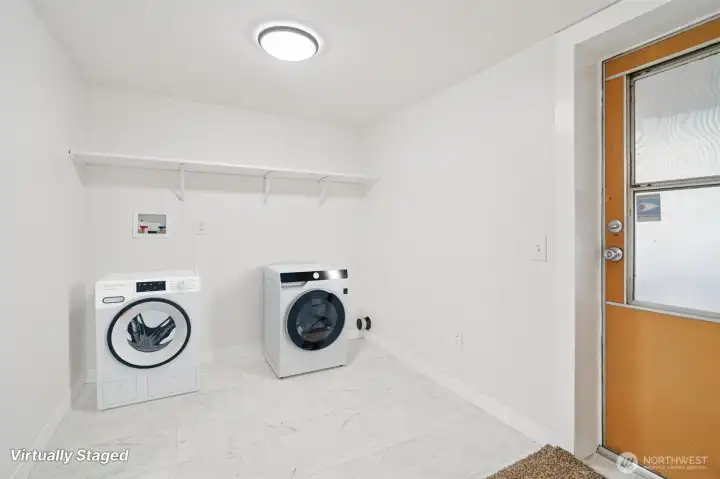 Large laundry room complete with new washer and dryer for added convenience