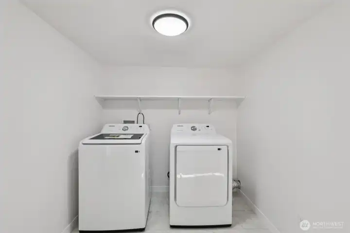 Large laundry room complete with new washer and dryer for added convenience