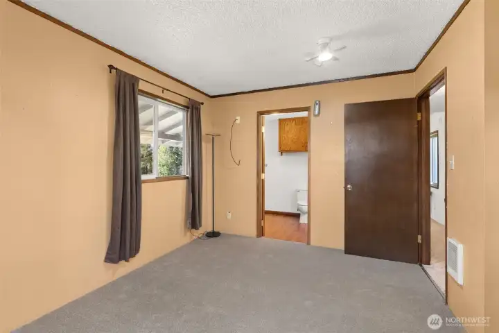 The primary bedrooms warm tones creates a cozy, welcoming atmosphere.