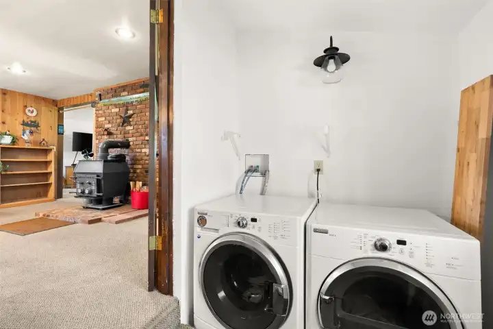 Enclosed porch/laundry/mud room with ample storage and space for freezer or extra refrigerator.