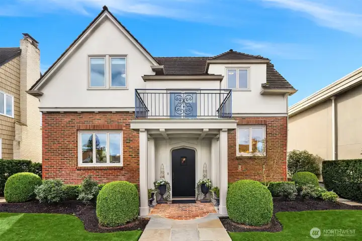 Professionally landscaped yard, stone walkway and inviting covered porch create beautiful curb appeal.