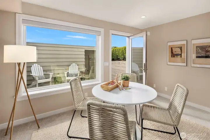Door out to lower patio, yard, and two-car garage