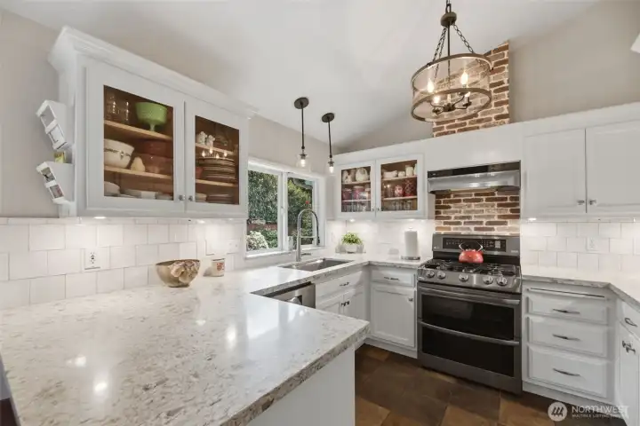 Quartz countertops and newer stainless steel appliances.