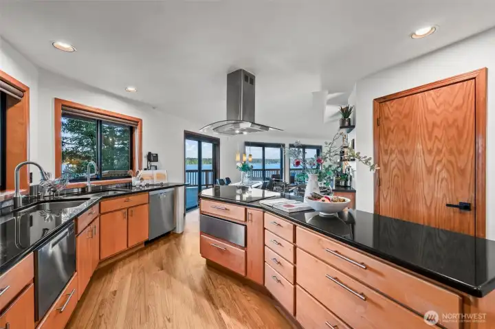 Large kitchen with ample cabinetry, modern finishes, and views toward the water.