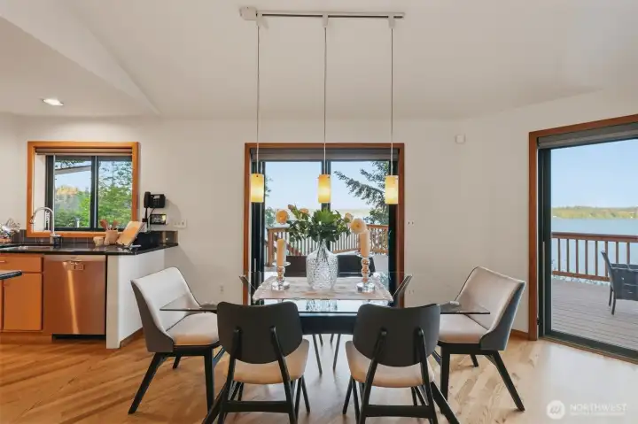 Open dining space with easy access to outdoor entertaining areas overlooking the water.