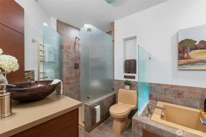 Bath area with textured glass details and spacious walk-in shower.