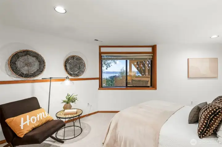 Bright bedroom featuring neutral tones and peaceful outdoor outlooks.