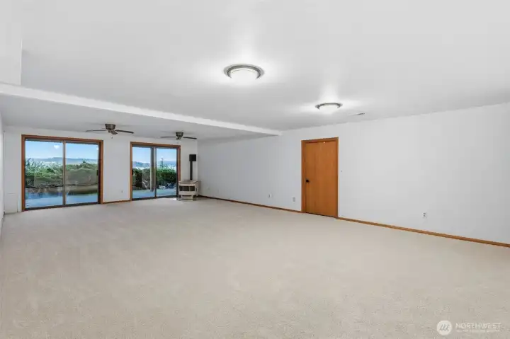 Bright lower-level gathering space with direct access to the patio and outdoor areas.