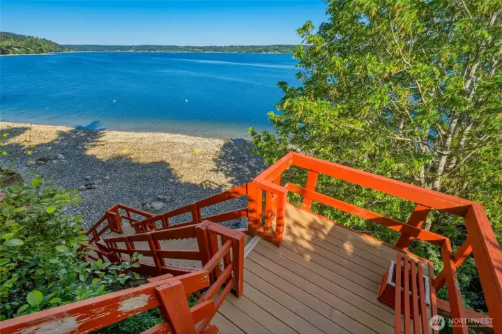 Waterfront access with stairs descending to the shoreline and open water views.