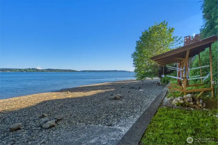Pebble beach shoreline with expansive water and territorial views.