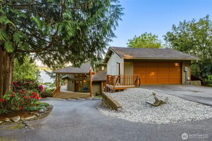 Circular driveway approach with attached garage and welcoming front entry.