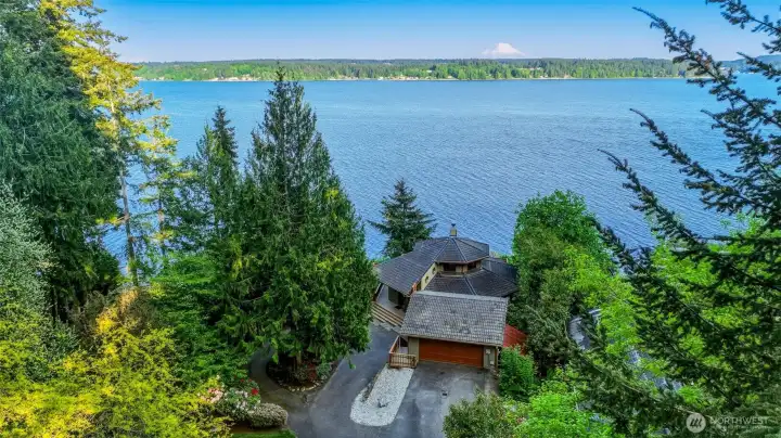 Aerial view capturing the property’s natural setting and waterfront location.