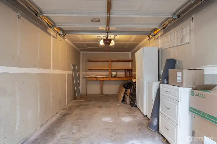 Garage interior has shelving and cabinets