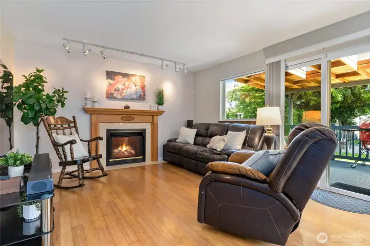 Living room off kitchen area with cozy gas fireplace.