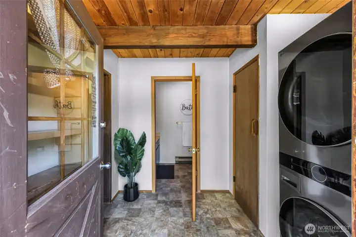 Front entrance into utility room with newer washer and dryer