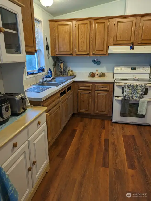 LOTS OF STORAGE. Coffee hutch, appliance center keeps glasses close to the beverages, teas, juices and drinks. Sink delivers sweet well water, fresh for drinking, savory soups, or canning. Stove has vented hood to keep kitchen smelling fresh.