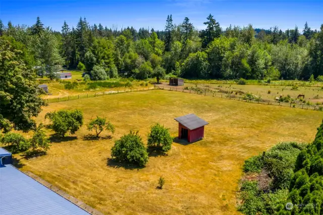 The rear property is fenced with a small out building.